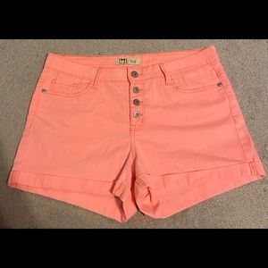 light pink jean shorts w multiple buttons in front